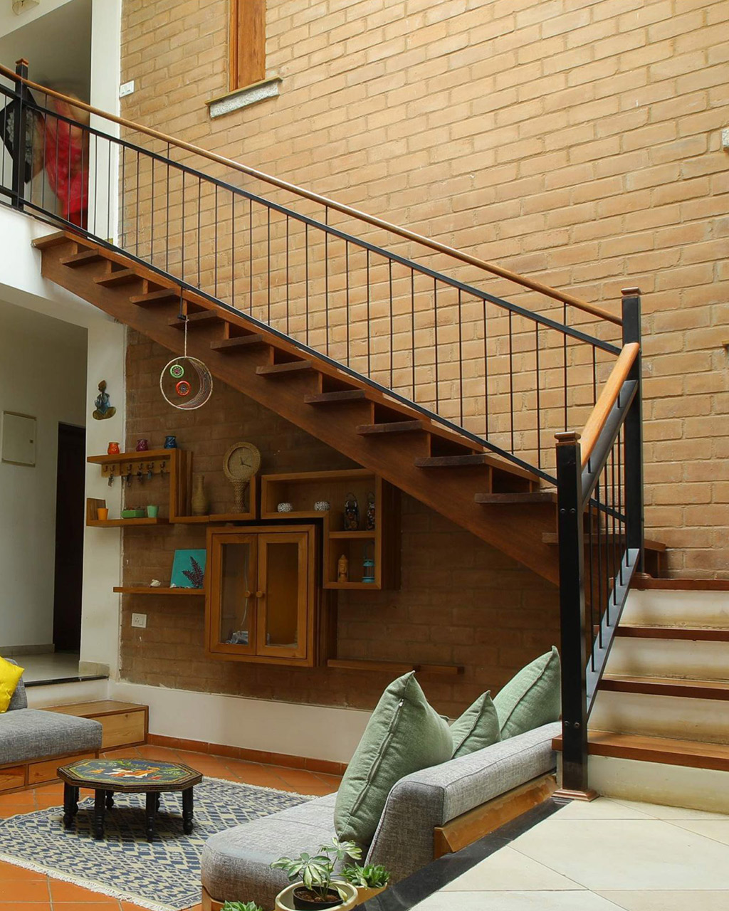 Timber staircase with metal railing and concrete mid landing